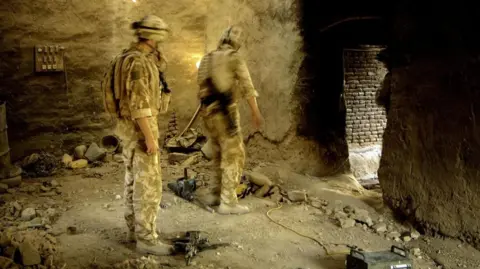 GB British soldiers (troops) A3 Commando Brigade Royal Marines search a known Taliban firing position in No Mans Land, Now Zad