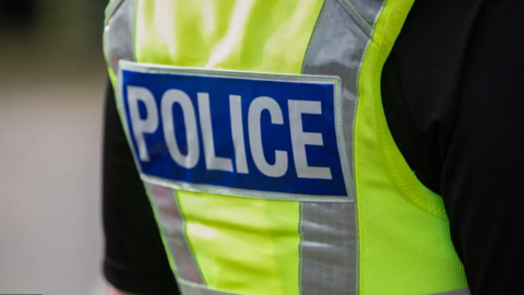 The back view of a British police officer vest. 