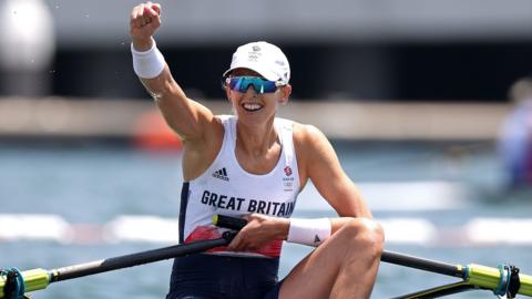 Victoria Thornley rowing and in her competitive Great Britain's sportswear is wearing sunglasses and a cap.