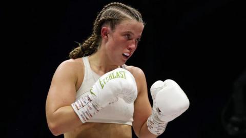 Francesca Hennessy in the ring with white gloves on