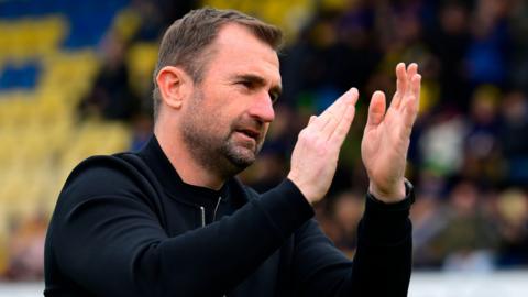 Torquay boss Paul Wotton applauding his side's fans after the match