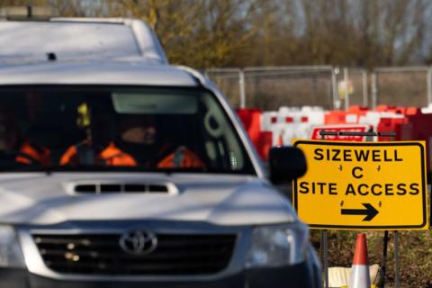 A white van passes the sign to the Sizewell C site