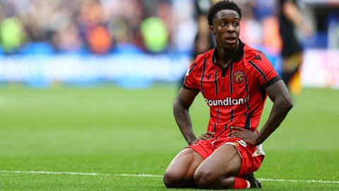 Walsall's Liam Gordon looks dejected kneeling down on the pitch after the final whistle at Wembley