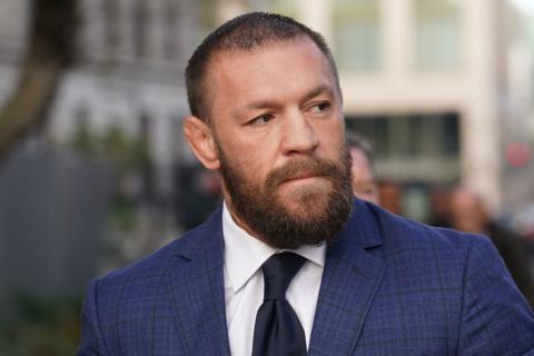 Conor McGregor in blue checked suit jacket, navy tie and white shirt