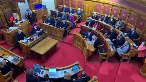 A view from the gallery of politicians sat in the States Chambers.