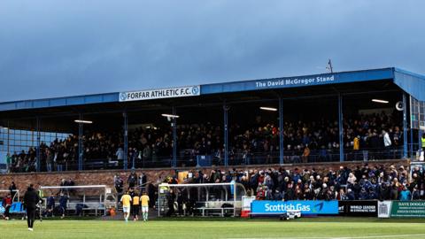 A large football stand with Forfar Athletic FC written on the roof