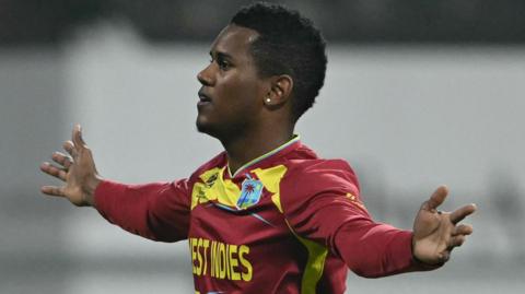West Indies bowler Akeal Hosein celebrates taking a wicket