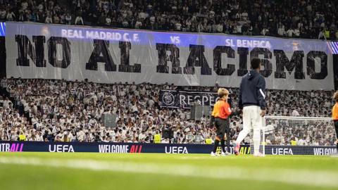 A banner with the words "no to racism" in Spanish is displayed before Real Madrid's game with Benfica at the Bernabeu