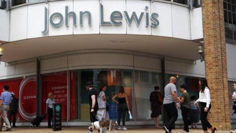 Exterior shot of a John Lewis store with shoppers walking past