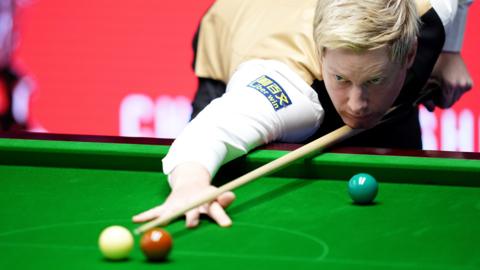 Neil Robertson plays a shot