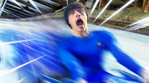 Joel rushes down a bobsleigh race track.