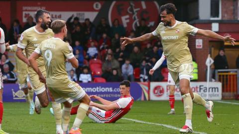 Swindon's Ryan Tafazolli celebrates opening the scoring at Fleetwood