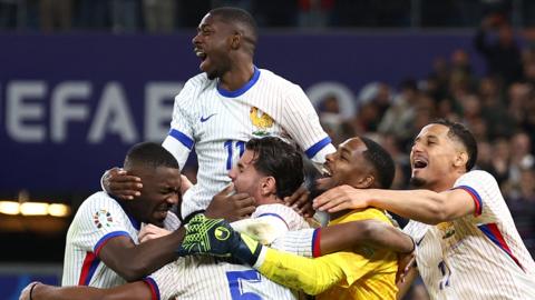 France celebrate beating Portugal on penalties