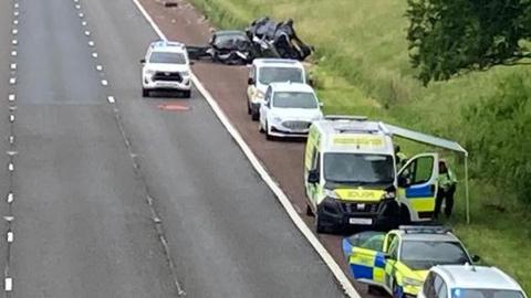 A view of a section of the M6 taken from a bridge showing the accident scene, with emergency vehicles on the hard shoulder