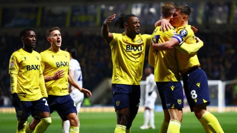 Oxford United players celebrating Michal Helik's goal against Luton Town