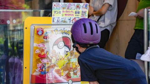 Child looking at Pokemon display in Japan.