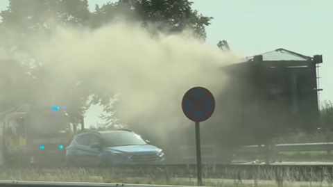 Smoke coming from a lorry with a car and fire engine also in view.