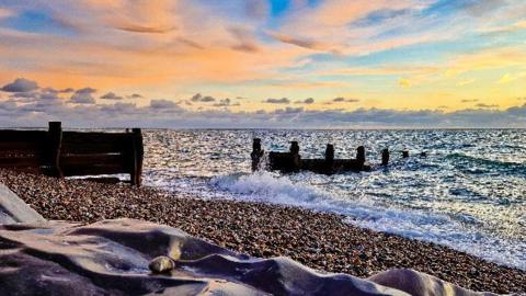 Sunset on a pebble beach.