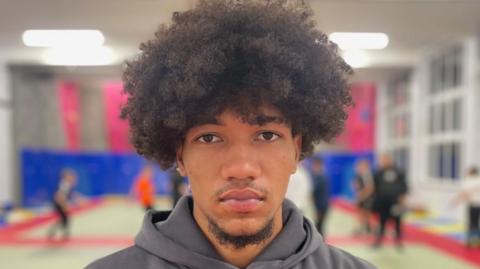 A picture of a young black man with Afro hair