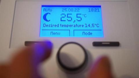 Photo of a wireless room thermostat in a home