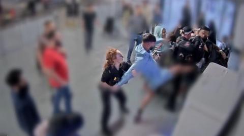 Video grab image issued by the Crown Prosecution Service (CPS)
from police body worn camera of footage of the alleged assault of three police officers at Manchester Airport which has been played to jurors at Liverpool Crown Court.