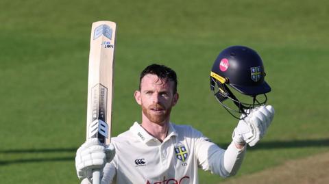 Graham Clark of Durham celebrates reaching his century
