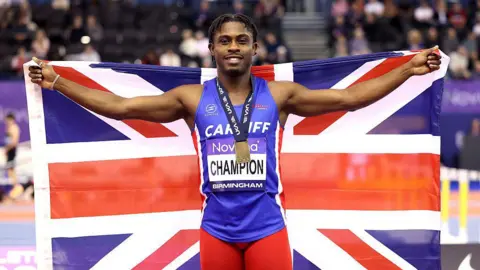 eremiah Azu of Great Britain poses for a photo with the gold medal after winning the men 60m finals 