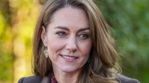 Kate, Princess of Wales. She's smiling.