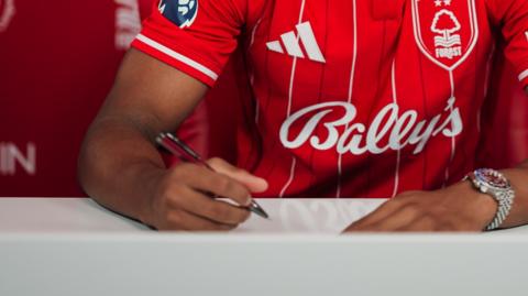 Close up of Nottingham Forest player signing contract
