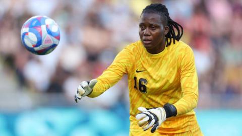 Chiamaka Nnadozie in goalkeeping kit with a football in shot