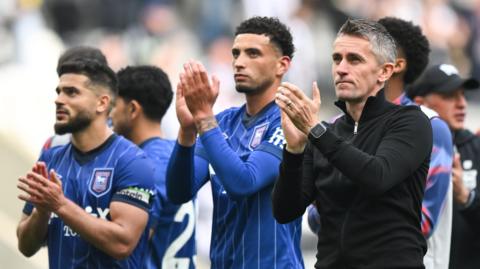Ipswich Town players and head coach Kieran McKenna applaud their fans after losing at St James' Park 