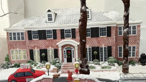 A small scale model of the Home Alone house, made of cake.