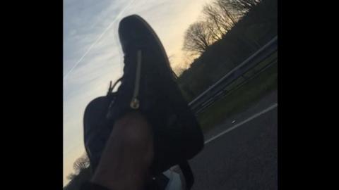 Feet out of car window on motorway - no socks on 