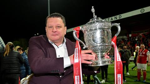 Kenny Bruce holds the Gibson Cup 