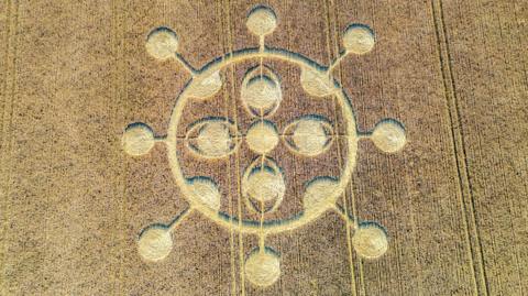 An aerial view of a crop circle in a field.