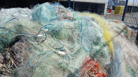 A pile of coloured fishing nets, lines and ropes which has been collected at Hamilton Dock in Lowestoft. 