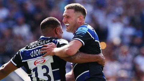 Max Ojomoh of Bath Rugby celebrates with team mate Finn Russell after scoring their second try during the Gallagher Premiership Rugby Final match between Bath Rugby and Leicester Tigers at Allianz Stadium on June 14, 2025 in London, England.