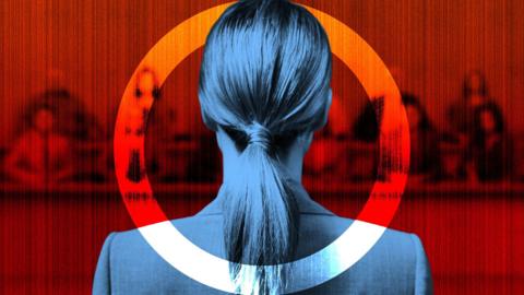 Back view of a woman with long hair in a ponytail, dressed in a dark suit, standing before a blurred red-toned background resembling a courtroom or formal panel. She is framed within a circular graphic element, partially red and white, creating a dramatic and symbolic visual effect. The overall atmosphere suggests seriousness and tension, possibly related to legal proceedings or justice.