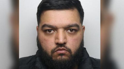 A police custody shot of Armaan Afsar