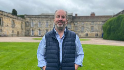 Stephen Wombwell standing in front of Newburgh Priory