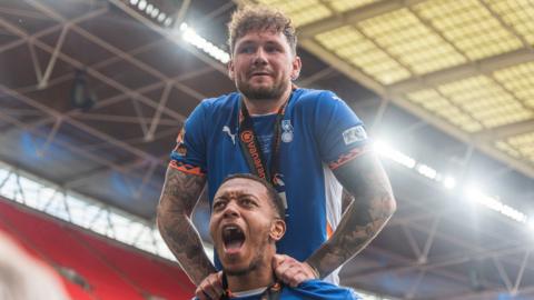 James Norwood and Shaun Hobson celebrate Oldham's victory in the National League promotion final