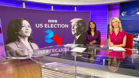 Sumi and Caitríona sat smiling behind the desk in the BBC News Washington DC studio