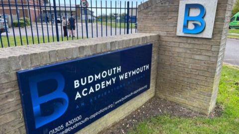 Blue sign at entrance of Budmouth Academy.