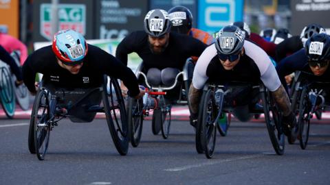 Daniel Romanchuk of the U.S. and Britain's David Weir in action during the men's wheelchair race at London Marathon