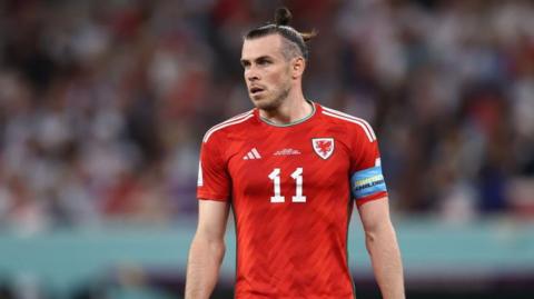 Gareth Bale, wearing the red Wales shirt with the number 11 on it 