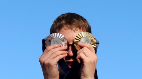 Swimmer Daniel Wiffen pictured with his Olympic gold and bronze medals in Paris. 