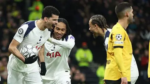 Tottenham players celebrate their second goal against Borussia Dortmund