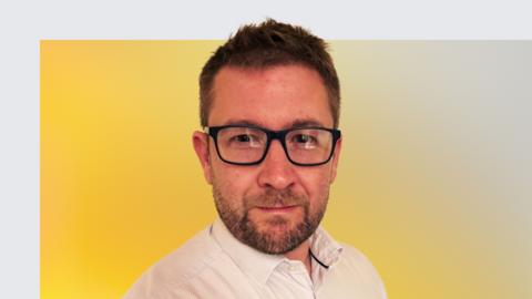 BBC Sport football reporter Nick Mashiter, smiling, against a yellow background