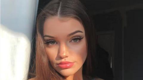 A selfie image of Chloe, who has long dark hair.
