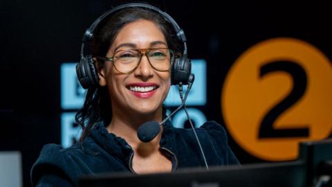 Tina Daheley in the studio, with the BBC Radio 2 logo in the background